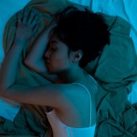 woman laying awake in bed